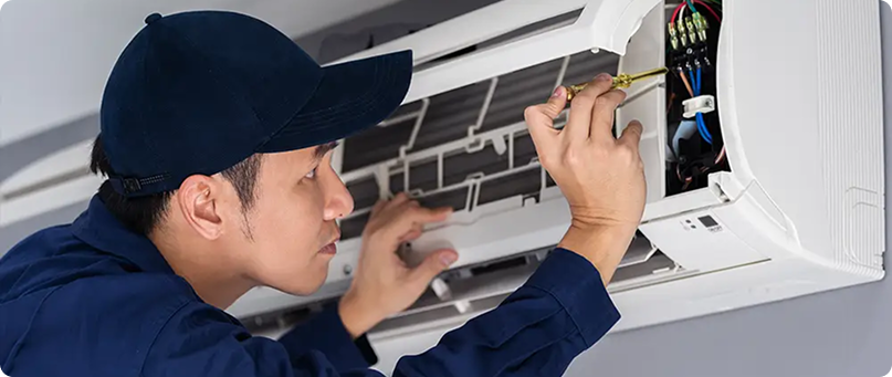 Technician working on AC unit