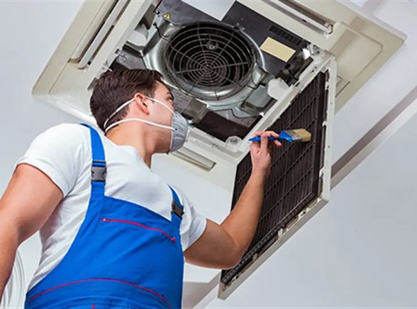 A technician working on an air conditioning system during installation